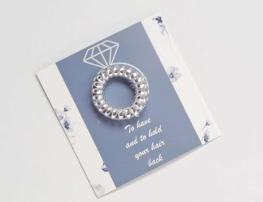 Bridesmaid silver coil hair tie on blue and white floral card with wedding ring design