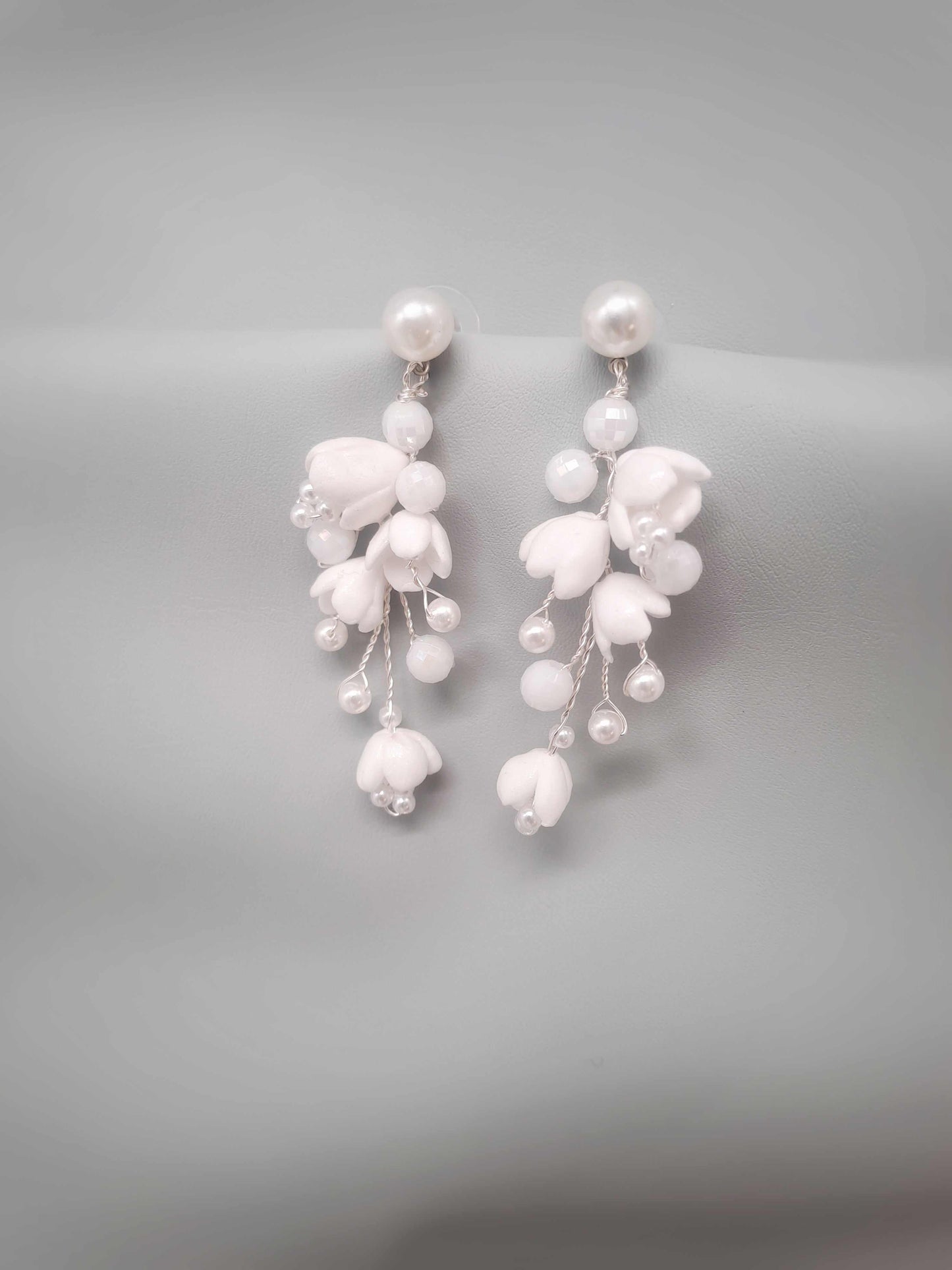 Pearl earrings on a gray background