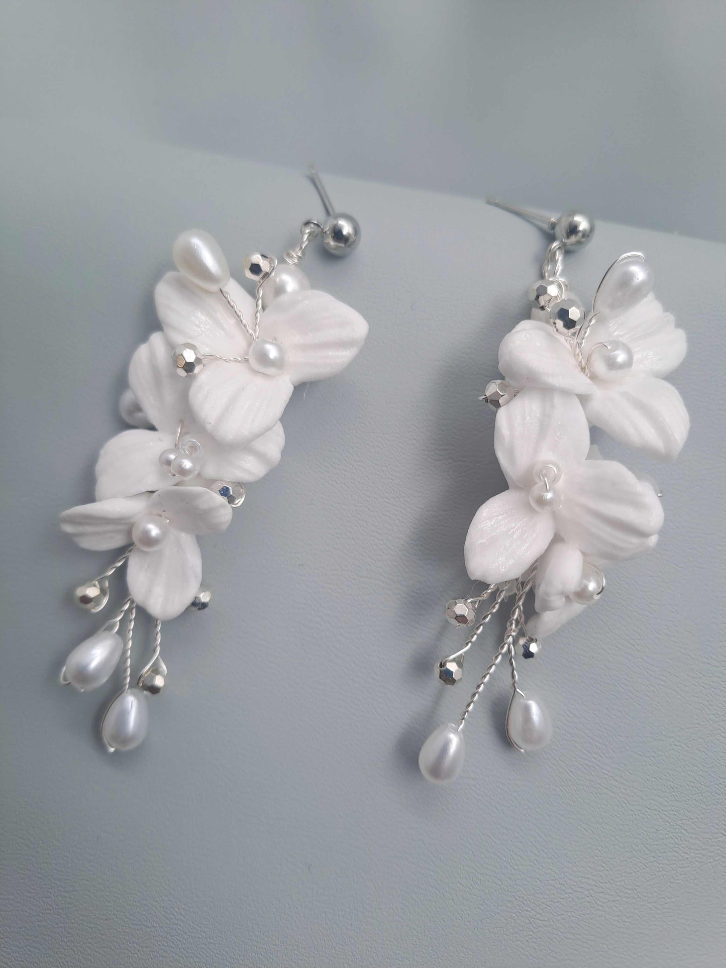 White polymer clay flower bridal earrings with pearl and silver embellishments, handmade and elegant wedding accessories