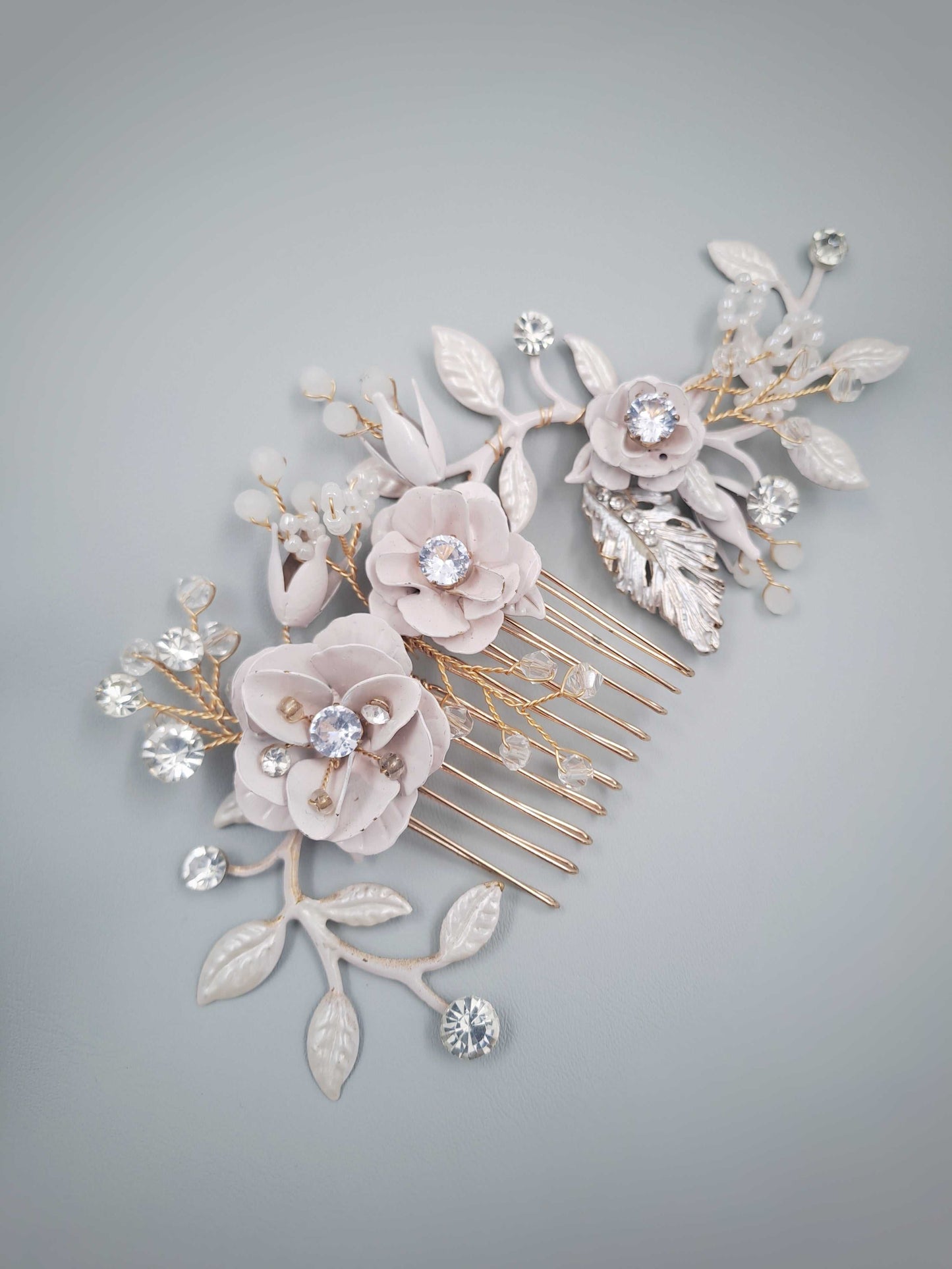 Blush bridal hair comb with handcrafted floral details and crystal accents for elegant bridal hairstyles