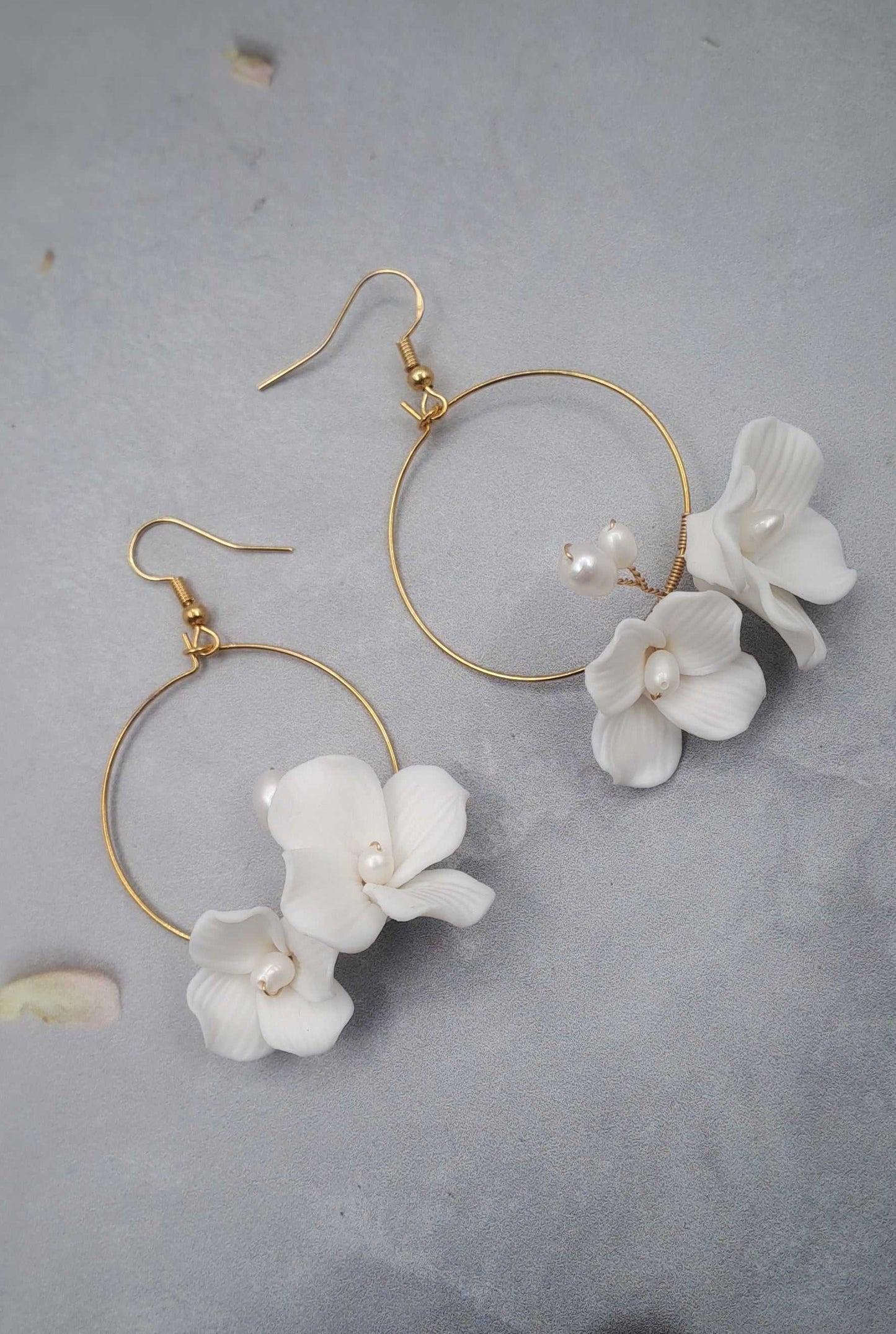 Gold hoop bridal earrings with white ceramic flower dangles