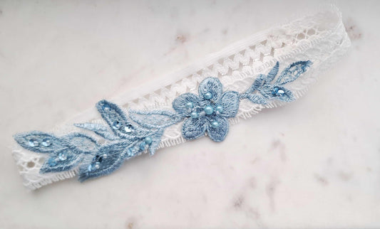 Lace bridal garter with light blue motif