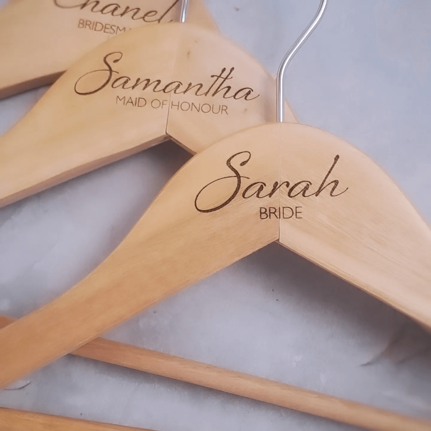 Personalised engraved wooden bridal party hangers with custom names and titles, perfect for weddings and keepsakes.