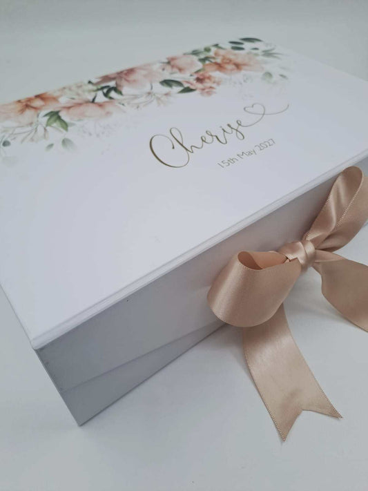 White gift box with floral design, ribbon, and 'Cherise' text on a light background