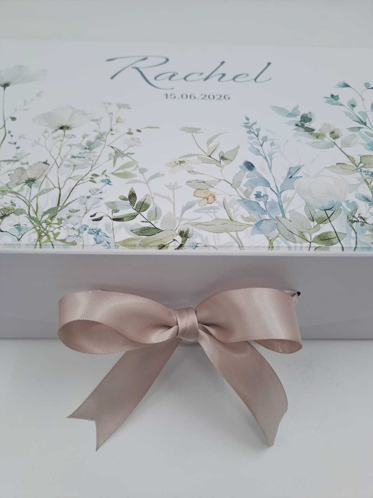 Gift box with floral design and a pink ribbon on a white background