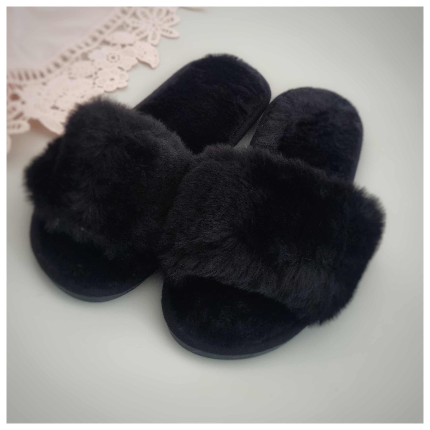 Black fluffy slippers with soft furry texture, cozy and comfortable design