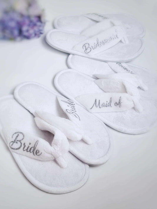 White bridal party thong towelling slippers with rubber sole, embroidered titles, one size fits all, washable.
