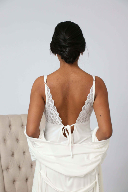 Woman wearing a white lace low back cotton two piece robe and gown set from the back