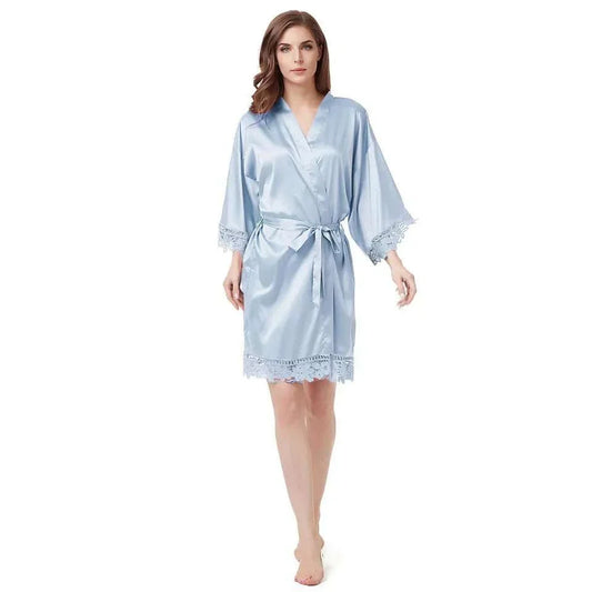 Woman wearing dusty blue satin robe with lace trim and tie waist