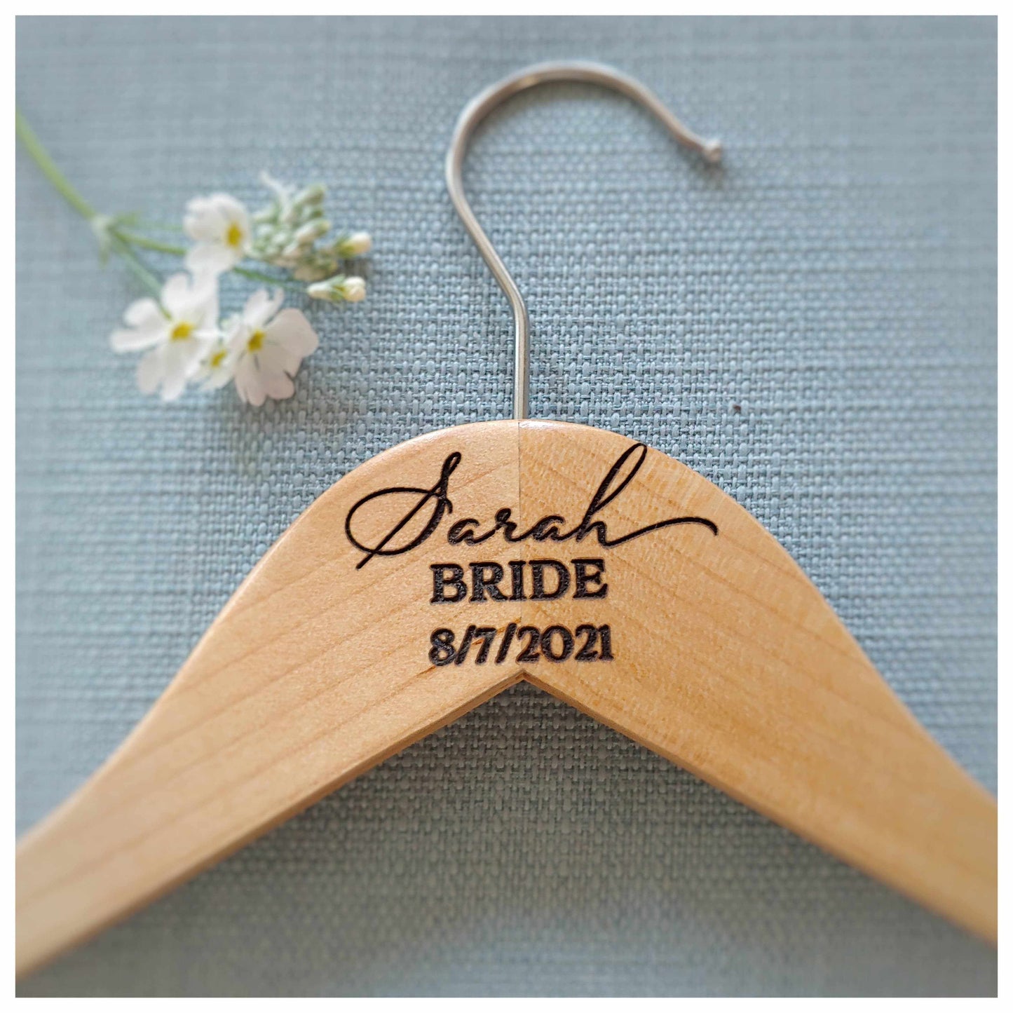 Personalised wooden hanger engraved with bride's name and wedding date for elegant wedding outfit display