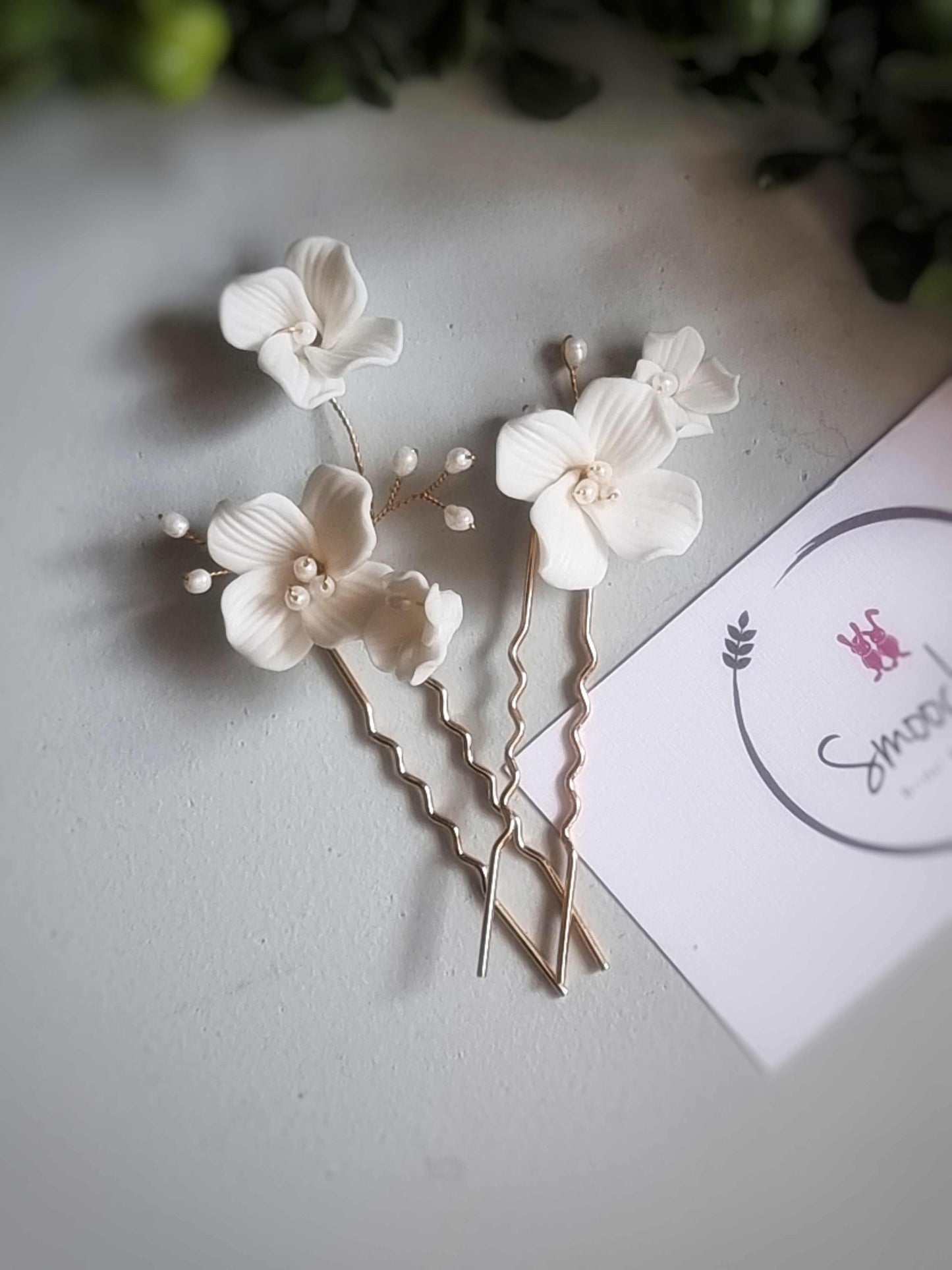 Set of two gold floral Salina hair pins with delicate white flowers and pearl accents for formal or bohemian hairstyles