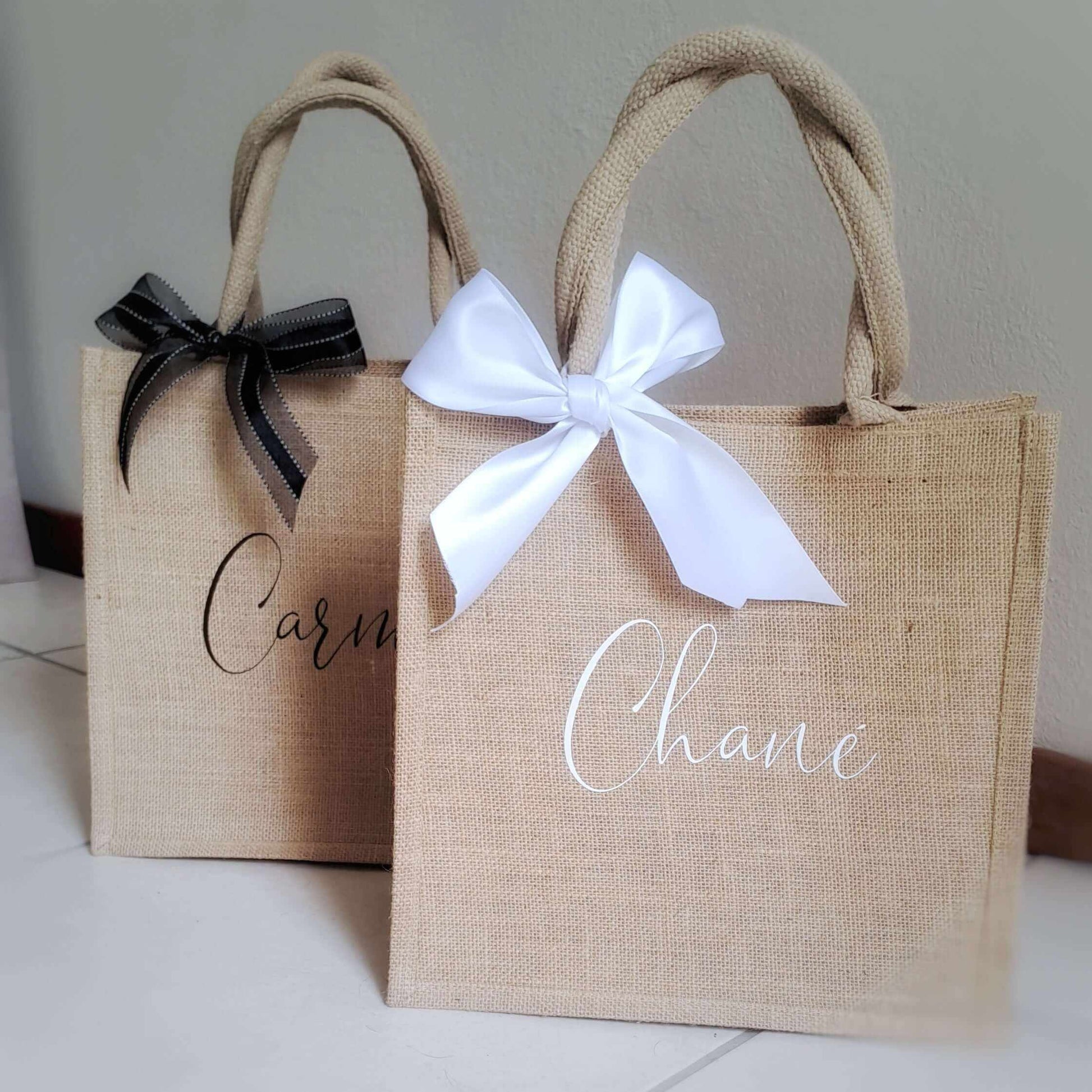 Personalized jute beach totes with white and black bows for bridal party gifts