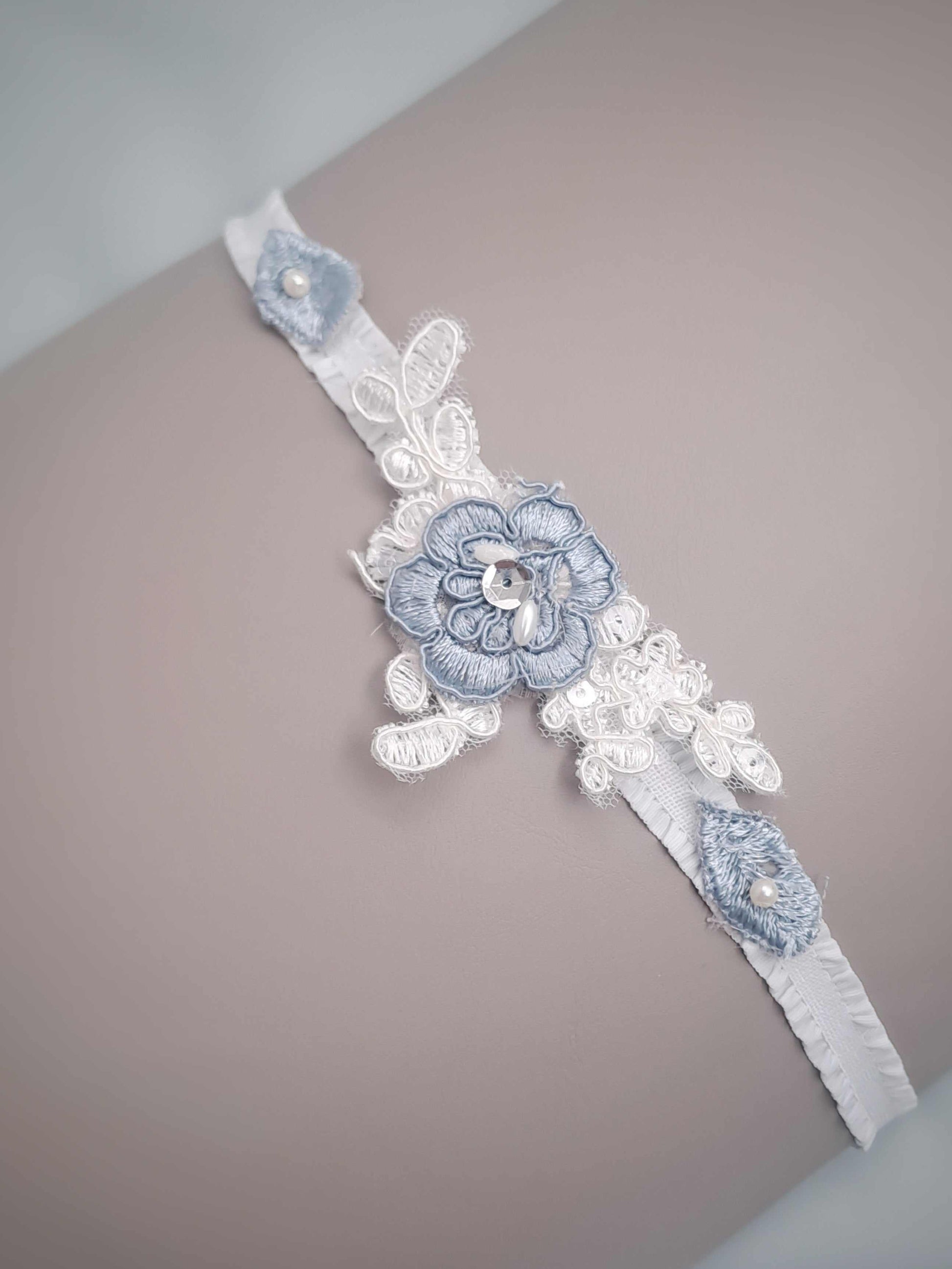 Decorative lace garter with floral designs on a neutral background