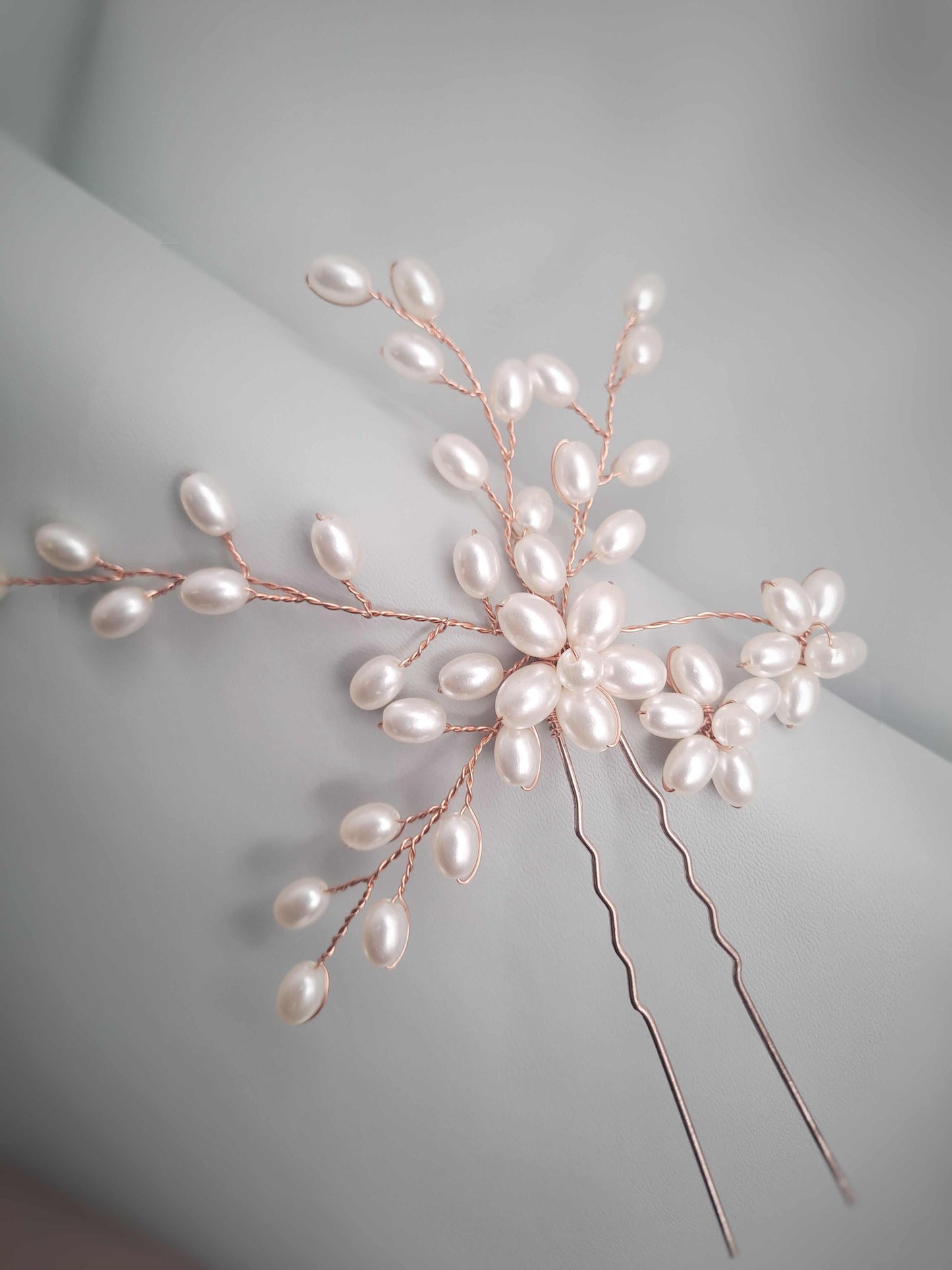 Pearl hairpin on a gray background