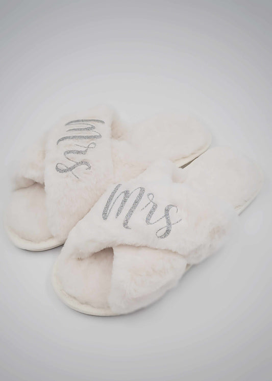 Ivory personalised fluffy criss-cross slippers with silver glitter "Mrs" writing for comfortable indoor wear