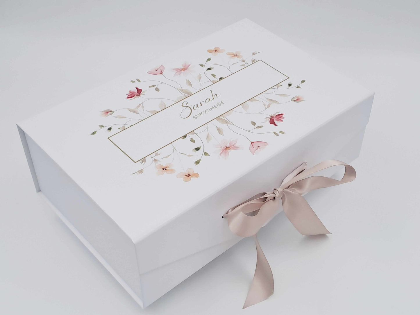 White gift box with floral design and ribbon on a white background