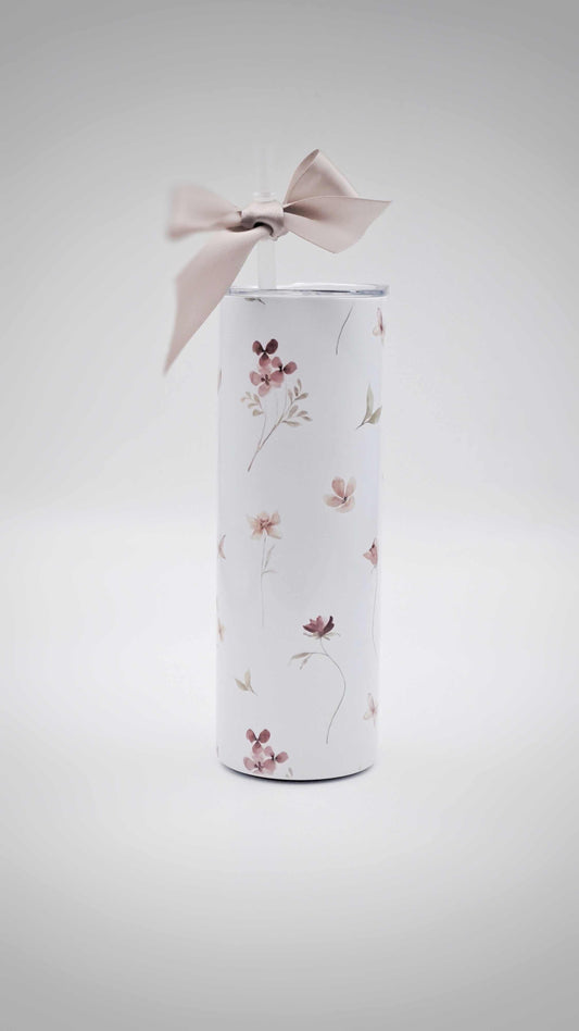 Personalised stainless steel tumbler with floral design and a bow on a light gray background