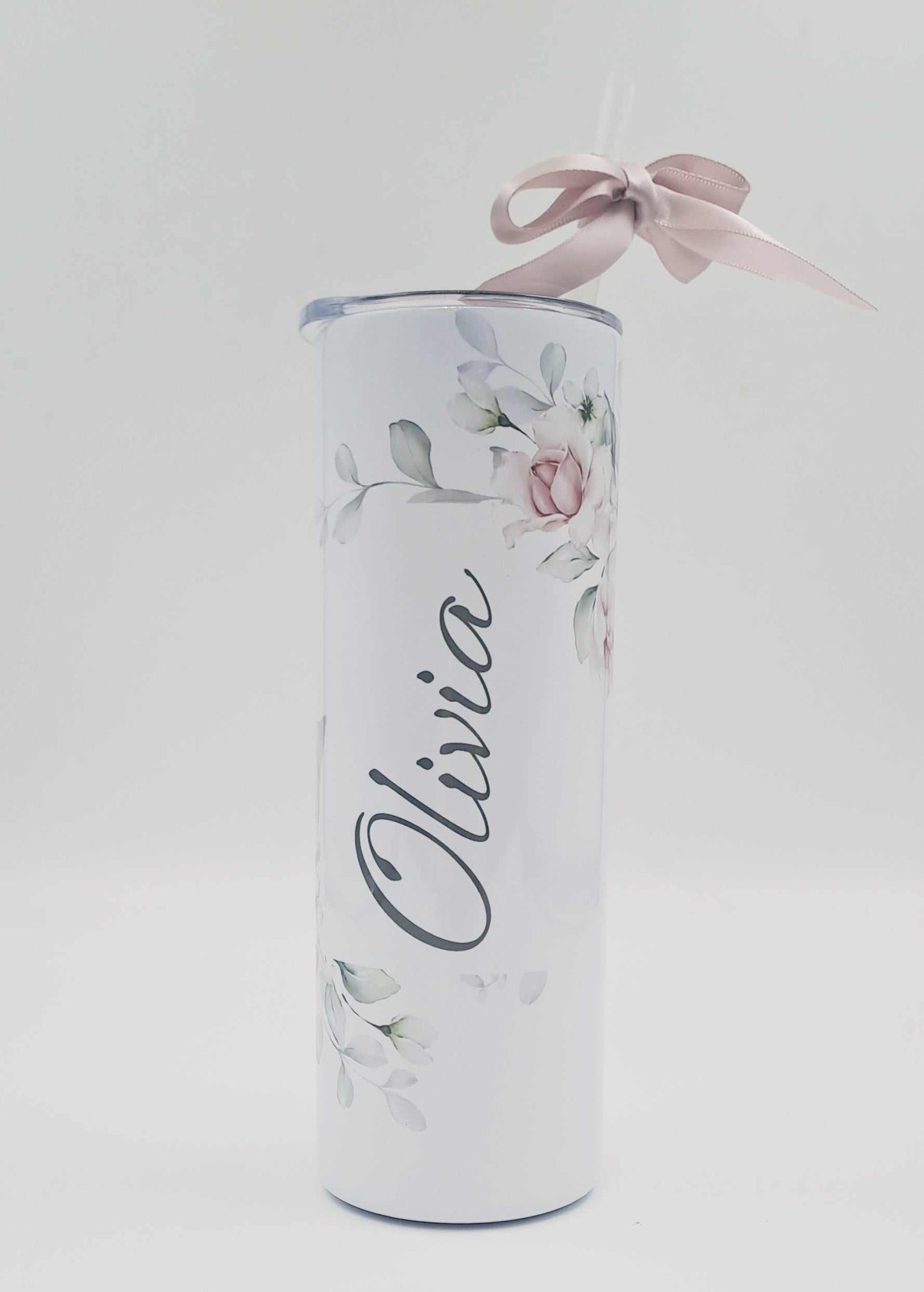Personalised stainless steel skinny tumbler with floral design, name Olivia, included straw, and pink gift ribbon.