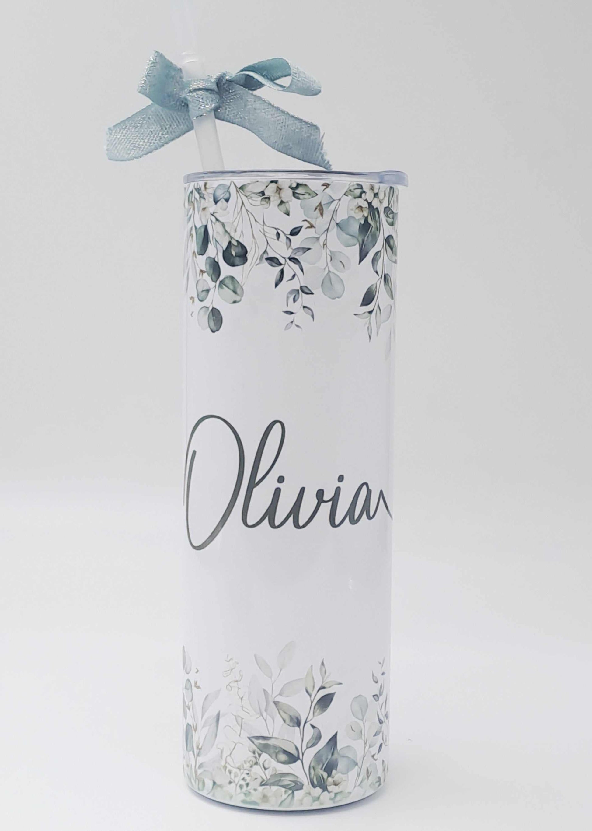 Personalised stainless steel skinny tumbler with floral design, custom name, included straw, and decorative blue ribbon for gifting.