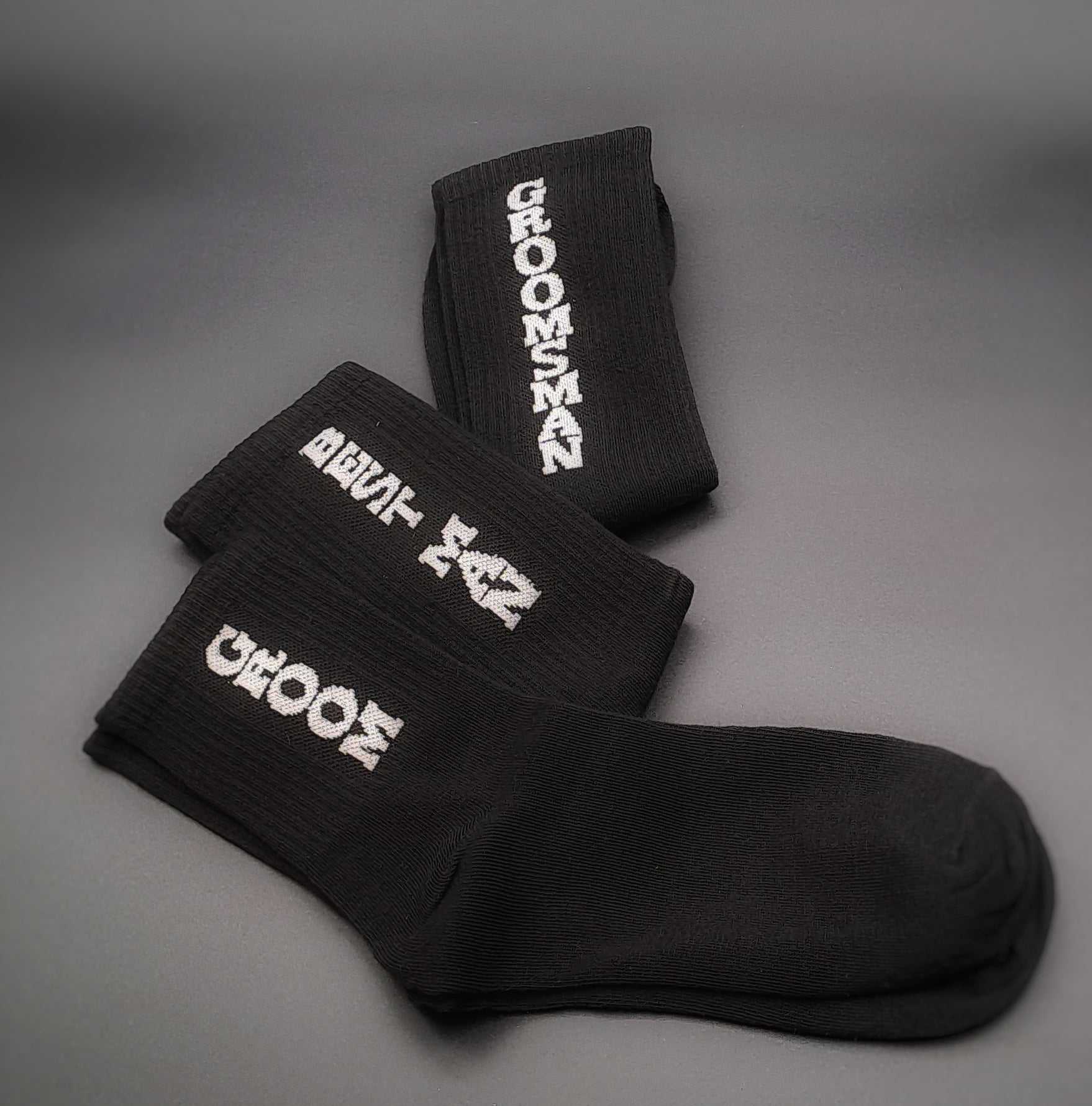 Black groomsman socks with white text for wedding day fun statement