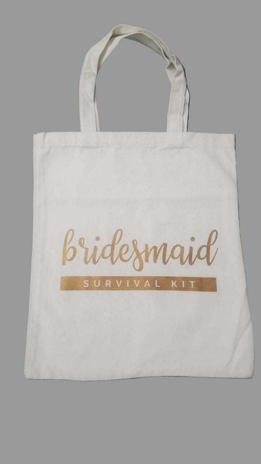 White tote bag with 'bridesmaid survival kit' text on a gray background