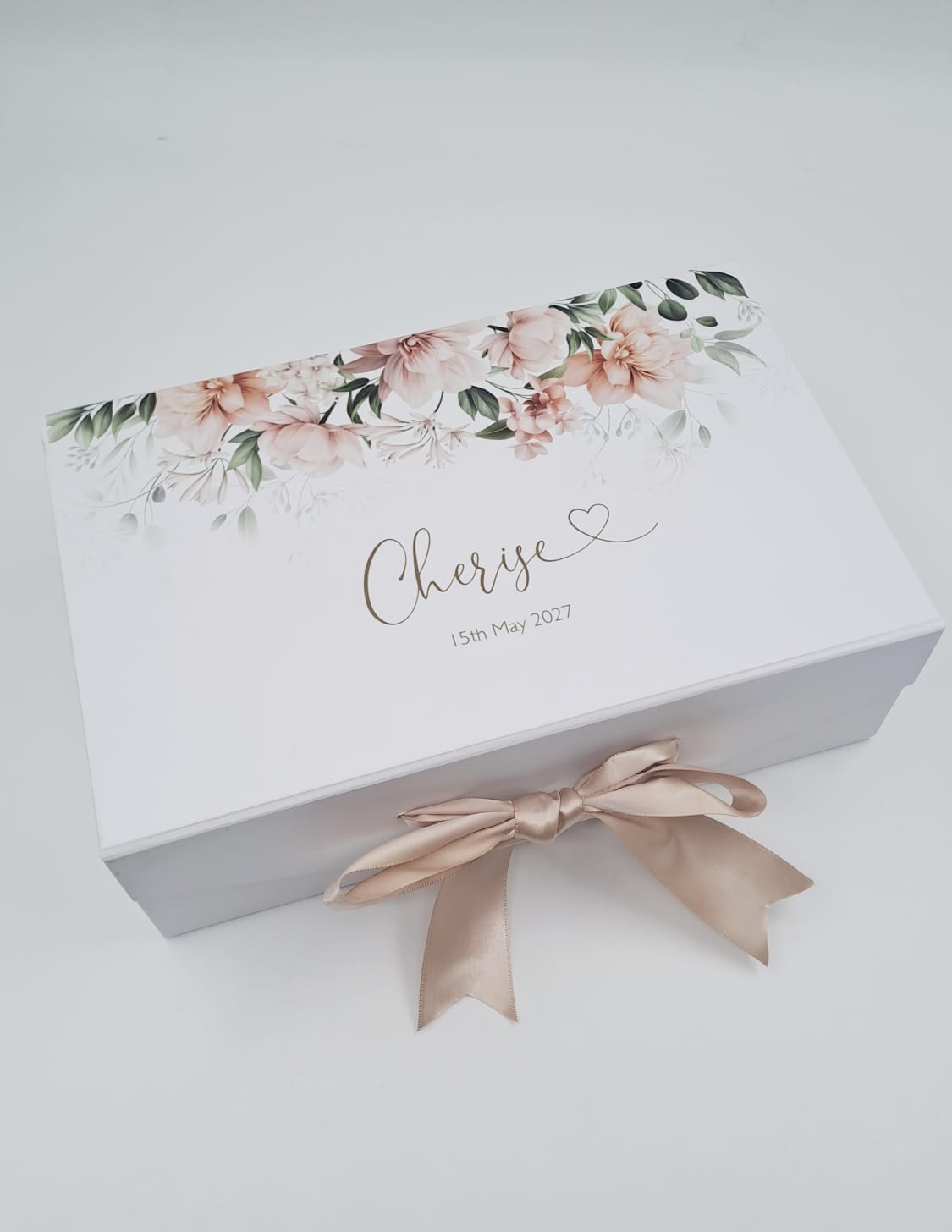Gift box with floral design and ribbon on a white background