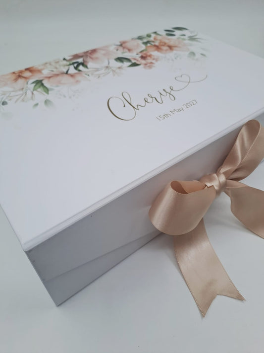 White gift box with floral design, ribbon, and 'Cherise' text on a light background