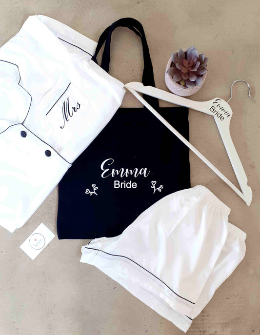 Bride Gift Combo with white satin pyjamas and black piping, black personalised tote, and engraved wooden hanger