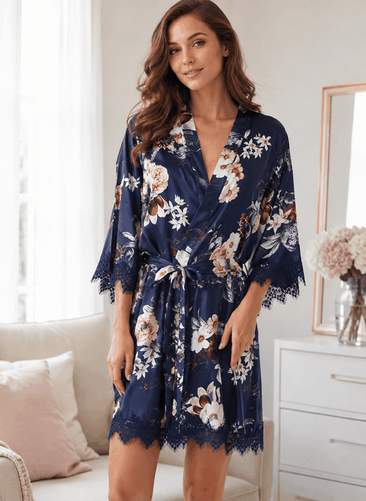 Navy floral gown in silky satin with pink and white blossoms, a self-tie belt, and scalloped lace trim on the sleeves and hem.