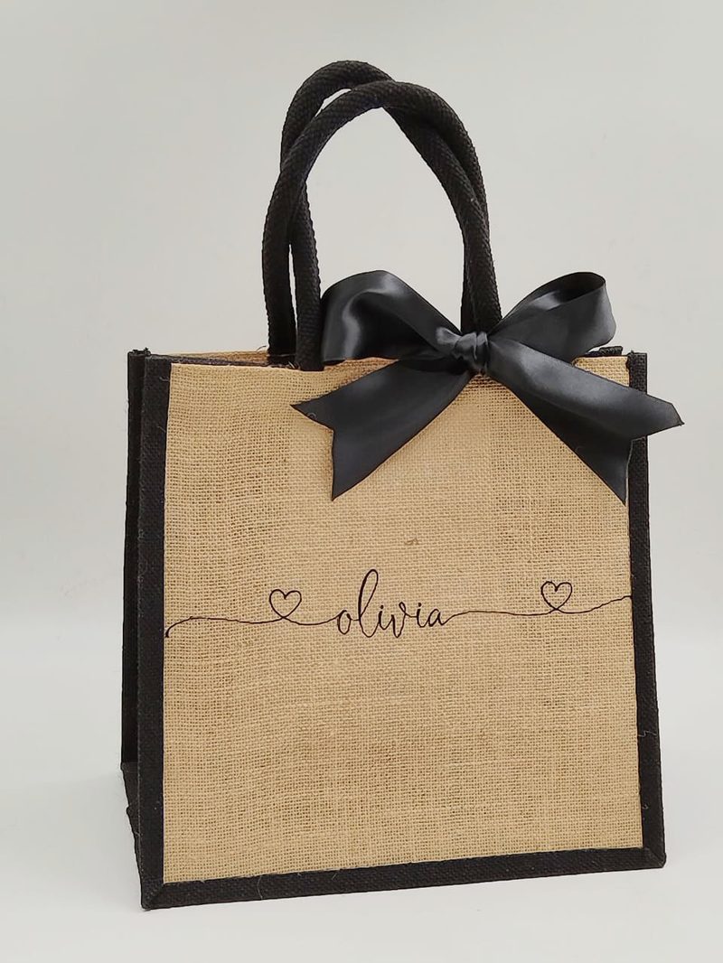 Personalised beach tote made of natural jute with black text and ribbon, spacious and durable for beach essentials